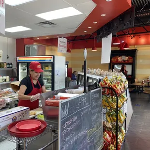 Behind the counter and premade sandwiches.