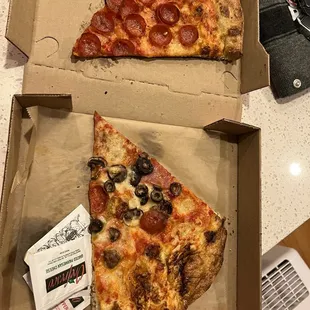 two slices of pepperoni and olive pizza