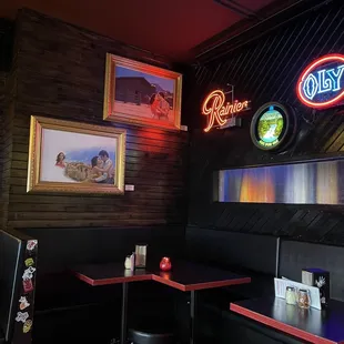 Corner tables with neon and art