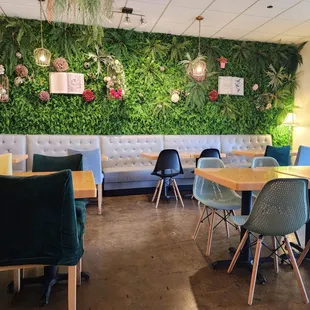 a dining area with a green wall