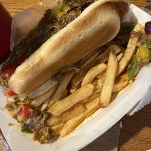 More fries under the 2 Philly Cheese Steak Dogs
