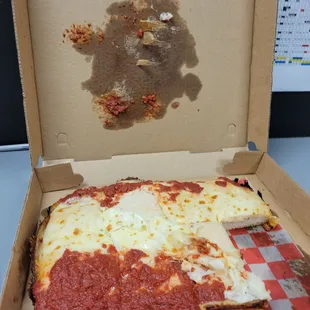 a piece of pizza in a box