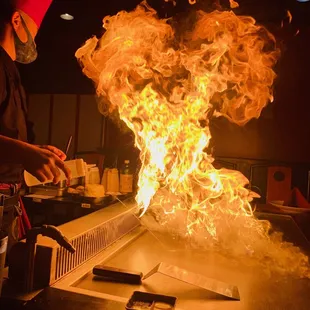 a man cooking on a grill