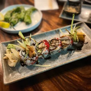 a plate of sushi on a wooden table