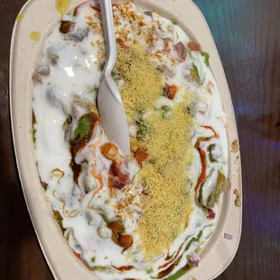 Aloo Tikka Chaat... chickpeas and veggies (similar to a pico de gallo) mixed in a creamy yogurt sauce