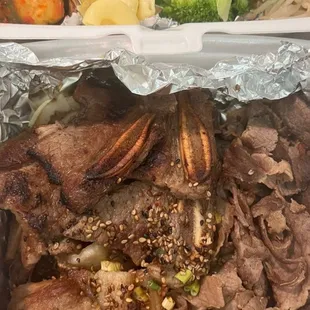 two trays of meat and vegetables