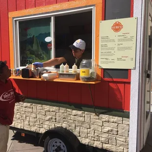 a woman ordering food from a food truck
