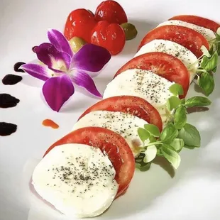a plate of tomatoes and mozzarella