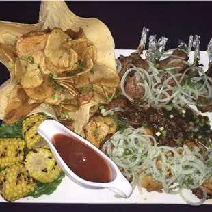 a plate of food with chips, corn, and salsa