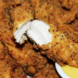 a plate of fried chicken with dipping sauce