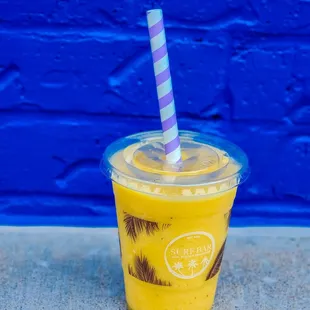 a drink in a plastic cup with a straw