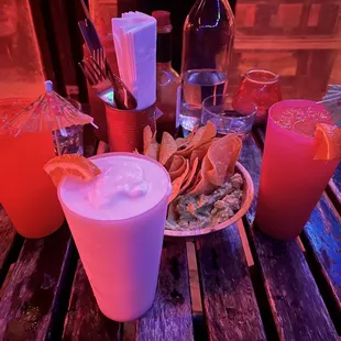 various drinks and snacks on a wooden table