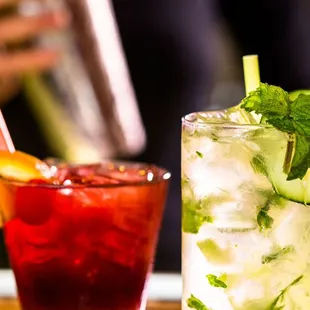 two cocktails on a wooden tray