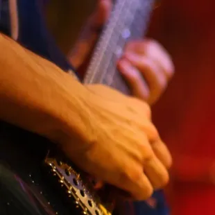 a close up of a person playing a guitar