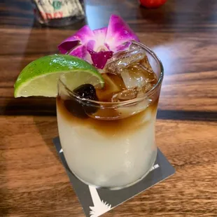 a drink with a purple flower