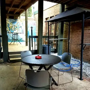 a patio with a table and chairs