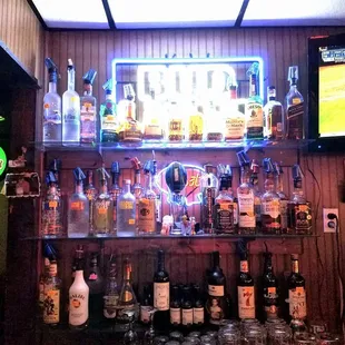 a bar with a lot of bottles and glasses
