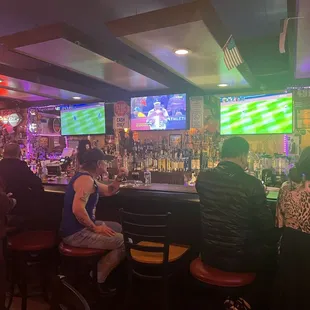 a group of people sitting at the bar