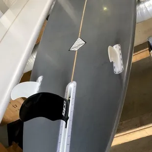 Bottom - Futures boxes, they even give you the 2 side fins. I bought the Center cutaway fin from them.