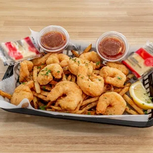 a tray of fried shrimp and fries