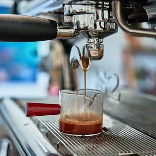 coffee being poured into a glass