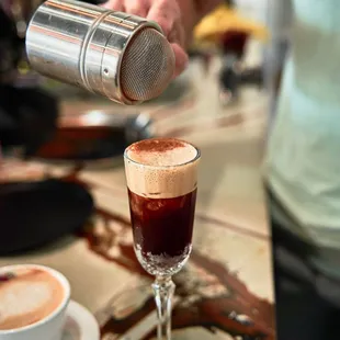 a person pouring a drink