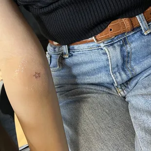 a woman with a tattoo on her arm