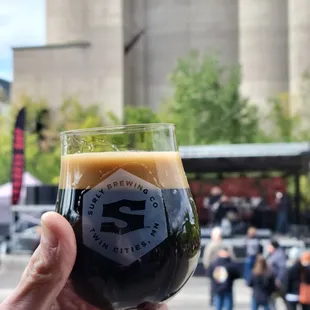 a person holding a glass of beer