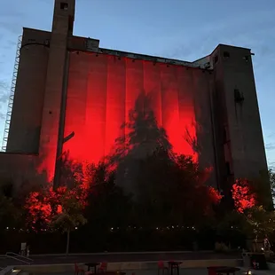 a silhouette of a man on a red wall