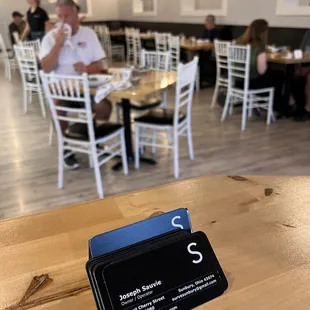a business card on a table in a restaurant