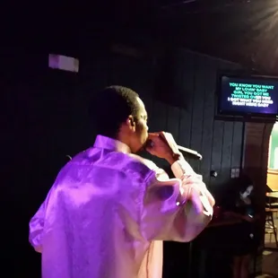 a man singing into a microphone