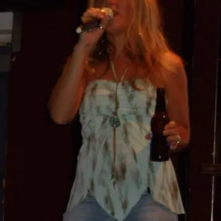 a woman singing into a microphone