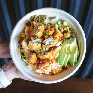 a person holding a bowl of food