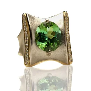 This stunning 4.03 cts. African Green Tourmaline Oval set in 18 Kt Two Tone Limited Edition Ring is truly a special piece...