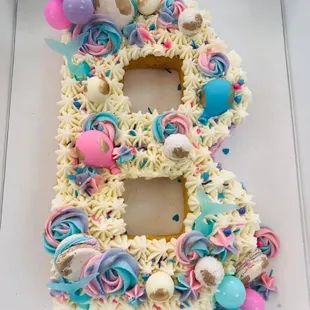the number eight decorated with cupcakes and candy