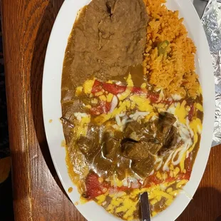 The Eddie's Special! Cheese enchiladas topped with lean carne guisada,the BEST rice &amp; beans. Also served with melt in your mouth tortillas!