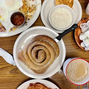 a breakfast of eggs, bacon, sausage and coffee