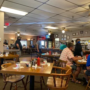 people sitting at tables in a restaurant