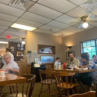 a group of people eating in a restaurant