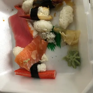sushi and cauliflower in a styrofoam container