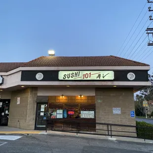 A portrait of Sushi 101 at night