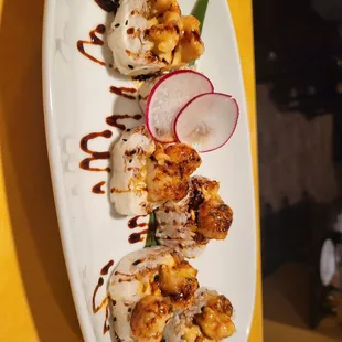 a plate of sushi with a side of radishes