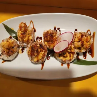 a plate of sushi on a yellow table