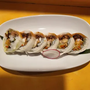 a plate of sushi on a yellow table
