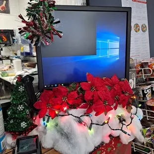 a desk with a computer and christmas decorations