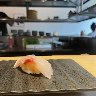 a sushi on a plate in a kitchen