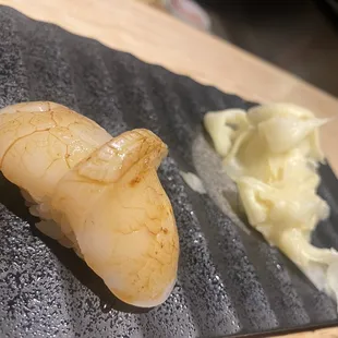 a close up of a sushi on a cutting board