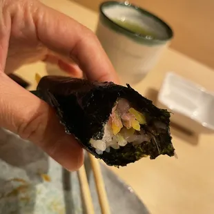Toro hand roll with chopped scallion and yellow Japanese pickle