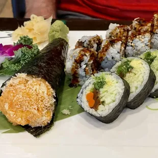 Spicy Salmon Hand Roll, Veggie Combo Roll, and Salmon Skin and Cucumber Roll