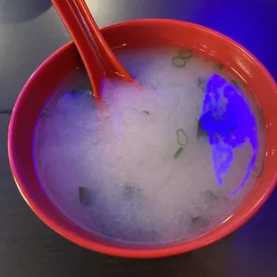 a bowl of soup with chopsticks in it